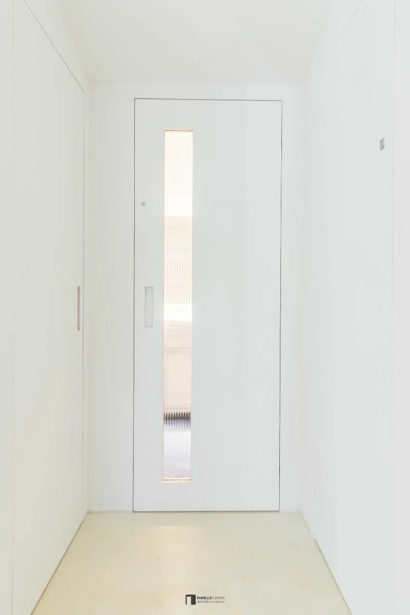 Invisible hinged door with glass insert closed